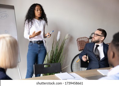 African American businesswoman mentor explaining project strategy at corporate meeting, giving flip chart presentation, employee presenting financial report with statistics, training staff - Powered by Shutterstock