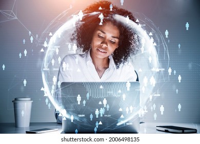 African American businesswoman sitting at the table and working on laptop conducting a research to hire high qualified employees for international projects. Concept of HR and new candidates.