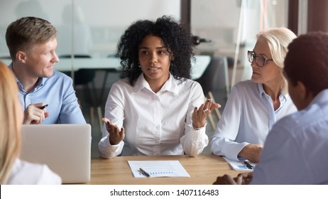 African american businesswoman talking to clients make business offer explain deal benefit convince diverse partners at group negotiation meeting, mixed race manager consult customers sell services