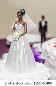 An African American Cake Topper Bride And Groom In The Back Ground