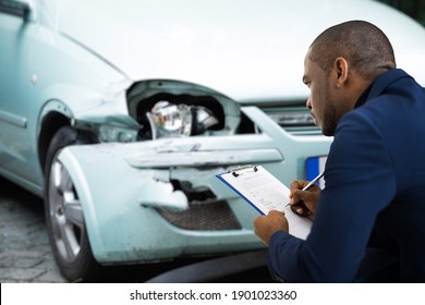 African American Car Insurance Agent Inspecting Accident Claim