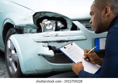 African American Car Insurance Agent Inspecting Accident Claim