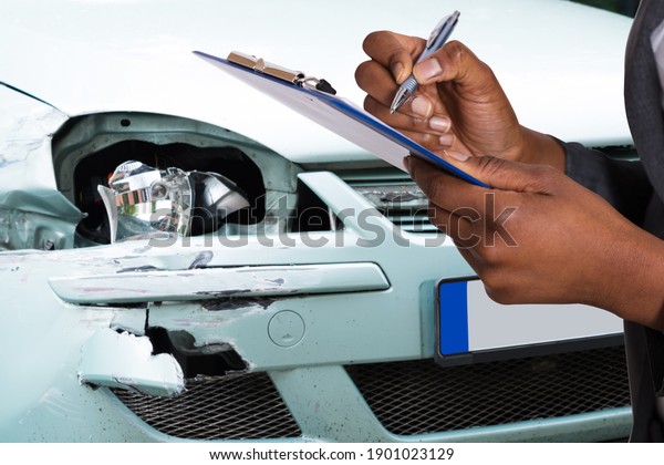 African American Car Insurance Agent Filling\
Accident Claim