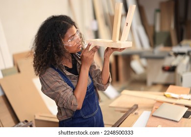African american carpenter happy working in making woodcraft furniture in wood workshop look professional high skill real people workman.
