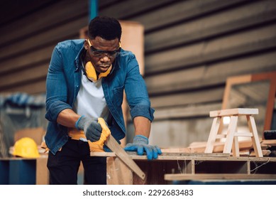 African american carpenter man working in wood factory, small business wood workshop. Timber industry and furniture factory. - Powered by Shutterstock