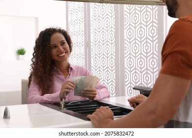 African American Cashier Counting Money At Cash Department Window In Bank. Currency Exchange