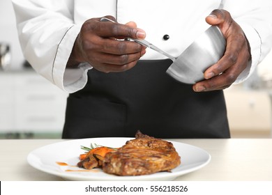 African American Chef Cooking Tasty Meat In Kitchen, Closeup