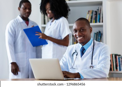 African American Chief Physician With Medical Team At Hospital