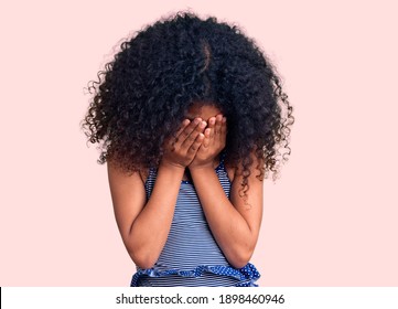 African American Child With Curly Hair Wearing Swimwear With Sad Expression Covering Face With Hands While Crying. Depression Concept. 