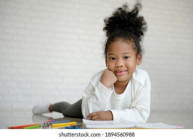 African American Children Draw And Paint  In The Bedroom.