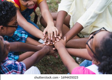 African American children have fun sitting join hands together for activity teamwork in the park, Education outdoor concept - Powered by Shutterstock