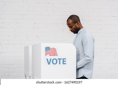 african american citizen voting near stand with vote lettering - Shutterstock ID 1627490197