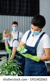 African American Cleaner In Medical Mask Cleaning Plant In Office