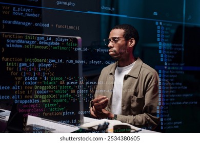 African American Coder Analyzing Complex Code on Screen