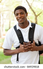 An African American College Student Smiling Holding School Supplies