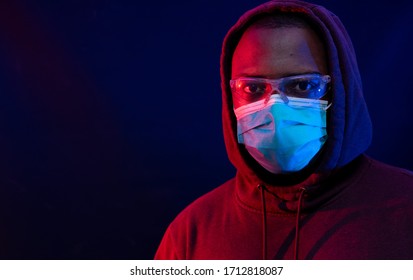 African American Community Is Hit Hard With The Current Coronavirus Pandemic, Conceptual Imagery Of Black Male Wearing Face Mask And Goggles With Look Of Concern 