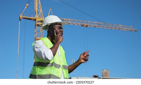 African American Constructor Talks On Phone With Team Member Looking With Upset Expression. Black Entrepreneur Makes Reports About Construction