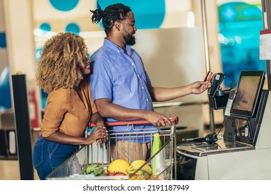 African American Couple with bank card buying food at grocery store or supermarket self-checkout - Shutterstock ID 2191187949