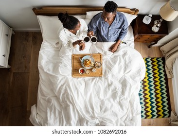 African American Couple In Bed Having A Breakfast In Bed