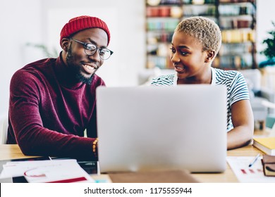 African american couple browse website on laptop computer making shopping online together at home interior, positive dark skinned hipster guy showing new app for netbook sitting at his girlfriend - Shutterstock ID 1175555944