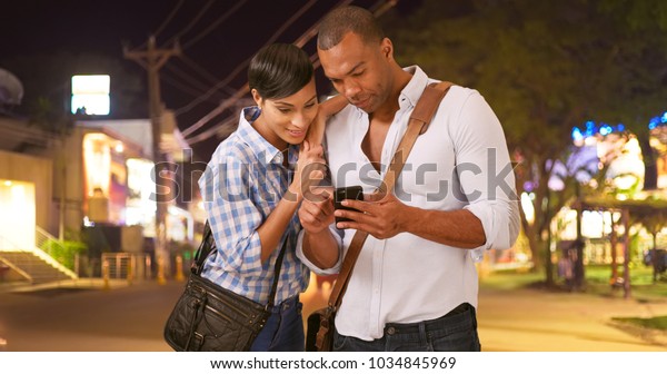 A African American couple calls a taxi while\
on a white background
