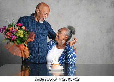 African American couple celebrating an anniversary together with flowers - Powered by Shutterstock