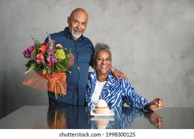 African American couple celebrating an anniversary together with flowers - Powered by Shutterstock