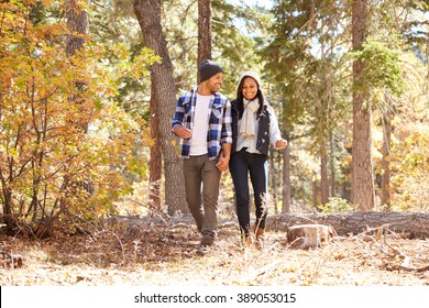  African American Couple Cycling Through Fall Woodland