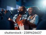 African American couple enjoying in movie projection in cinema. 