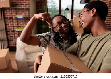 African American Couple Feeling Happy About New Property, Holding Keys To Family House And Moving In Together. Homeowners Celebrating Life Achievement And Starting New Beginnings.