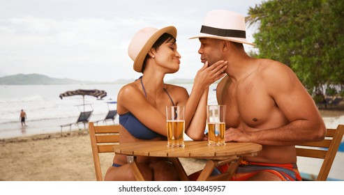  African American couple flirt while drinking at the beach - Powered by Shutterstock