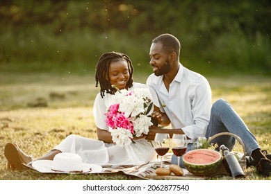 African American Couple With Flowers On A Summer Picnic