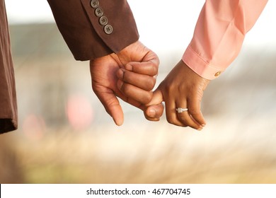 African American Couple holding hands.