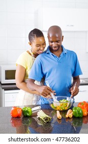 African American Couple In Kitchen Making Salad