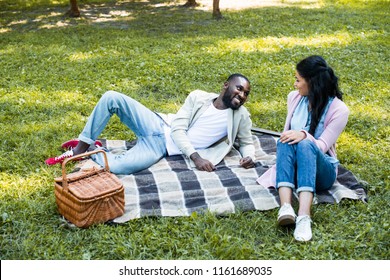 African American Couple Looking At Each Other At Picnic In Park