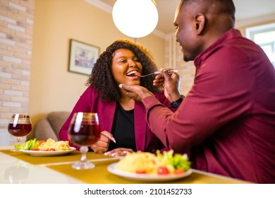 African American Couple In Love Drinking Wine From Glasses And Eating Italian Pasta In Living Room 14 February Valentines Day