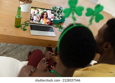 African american couple making st patrick's day video call to female friend on laptop at home. celebrating the irish patron saint's day at home in isolation during quarantine lockdown. - Powered by Shutterstock