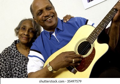 african american couple playing guitar