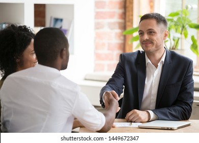 African American Couple Shaking Hand Of Manager, Realtor, Insurer At Meeting In Office, Wife And Husband Making Real Estate Deal, Purchase New House, Signing Contract, Successful Job Interview