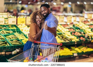 African American Couple Shopping For Healthy Fresh Food At Produce Section Of Supermarket.