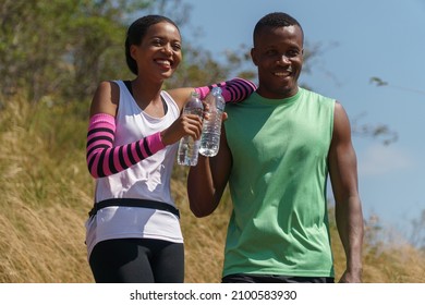 african american couple Trail running take a break Drinking Water in Meadow on mountain outdoors. sport adventure . black fit woman and man runner jogging on country path or cross-country in summer - Powered by Shutterstock