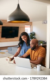 African American Couple Using Laptop To Check Finances At Home