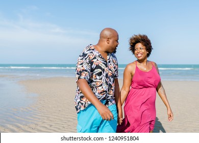 African American couple walking at the beach - Powered by Shutterstock