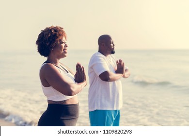 African American couple working out at the beach - Powered by Shutterstock