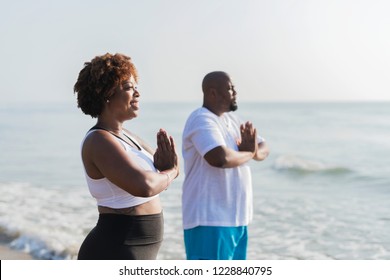 African American couple working out at the beach - Powered by Shutterstock