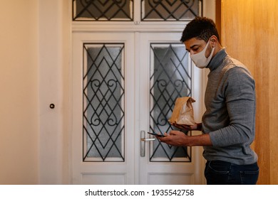 African American Delivery Man With Face Mask Delivering Takeout Food.