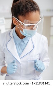 African American Dentist In Medical Mask, Face Shield And Latex Gloves