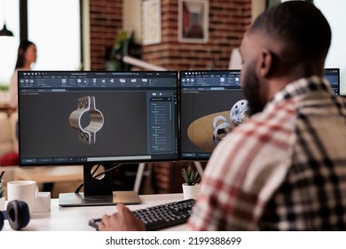 African american developer setting up gears model on manufacturing software, developing engine product for technical industry innovation. Creating turbine design with industrial cad science. - Powered by Shutterstock