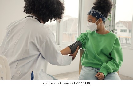 African American Doctor Is Measuring Blood Pressure And Checking Pulse Child Patient.