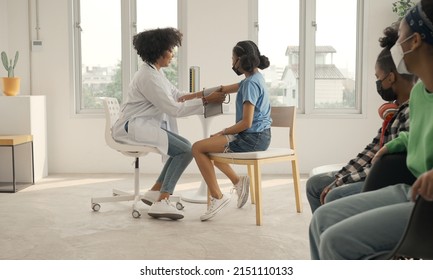 African American Doctor Is Measuring Blood Pressure And Checking Pulse Child Patient.